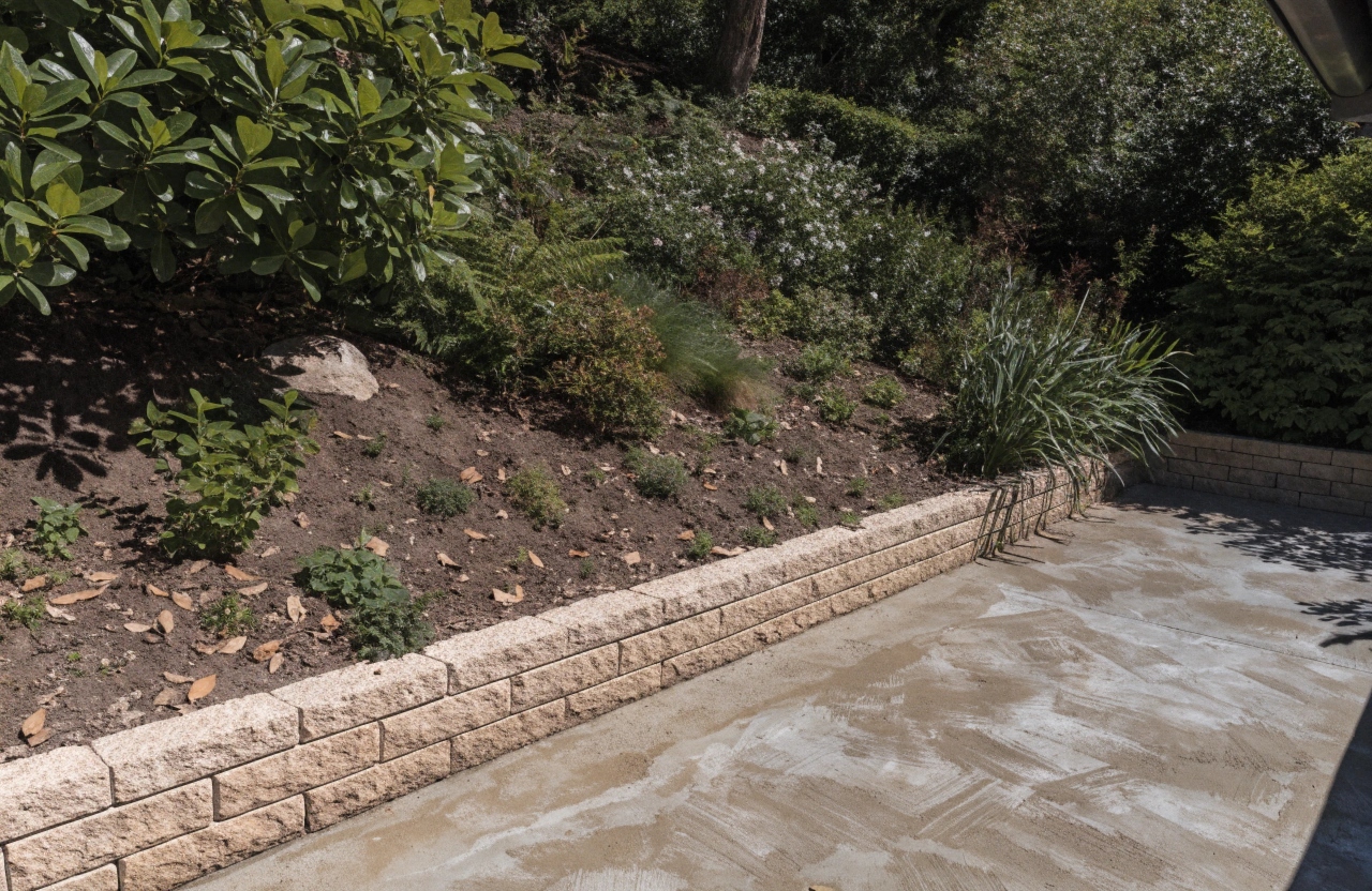 Concrete slab poured against a retaining wall on a sloping Fisher property