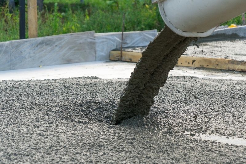 wet concrete is being poured in the concrete forms
