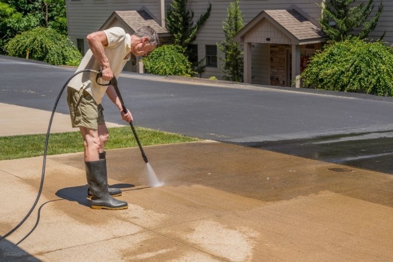 water cleaning the concrete driveway
