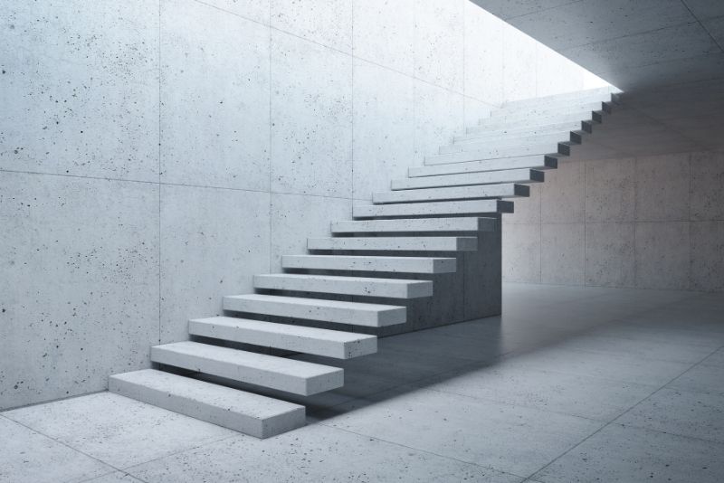 modern concrete stairway attached to the concrete wall