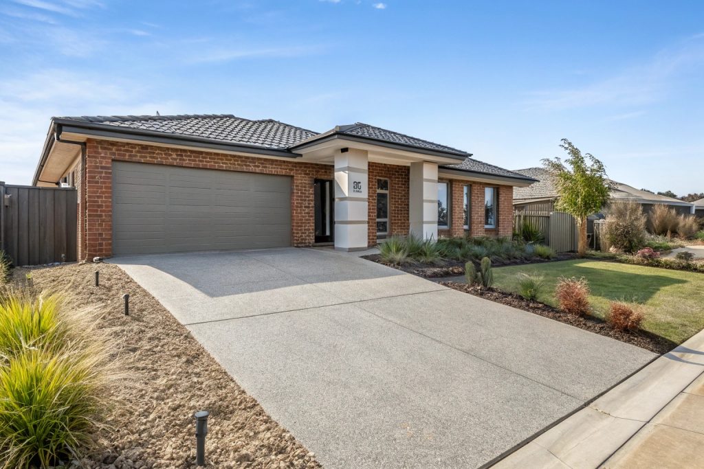 Modern Gungahlin home with exposed aggregate concrete driveway showing quality finish and curb appeal