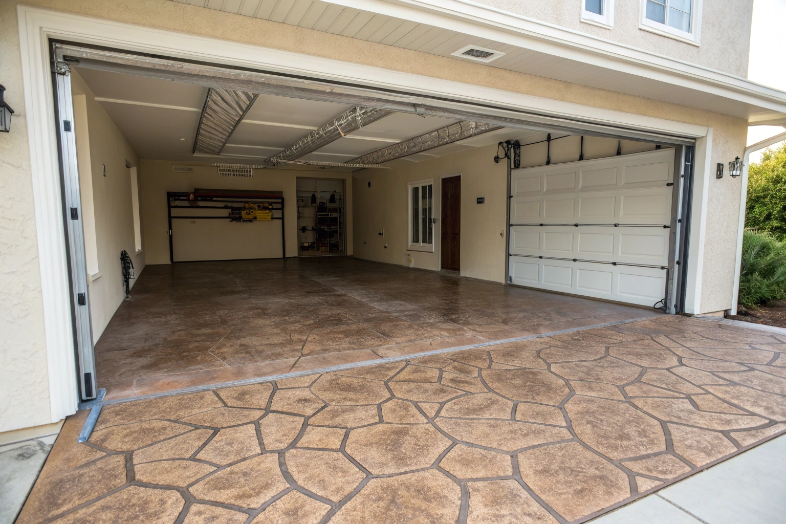 Stamped concrete garage slab with decorative pattern enhancing property value and curb appeal